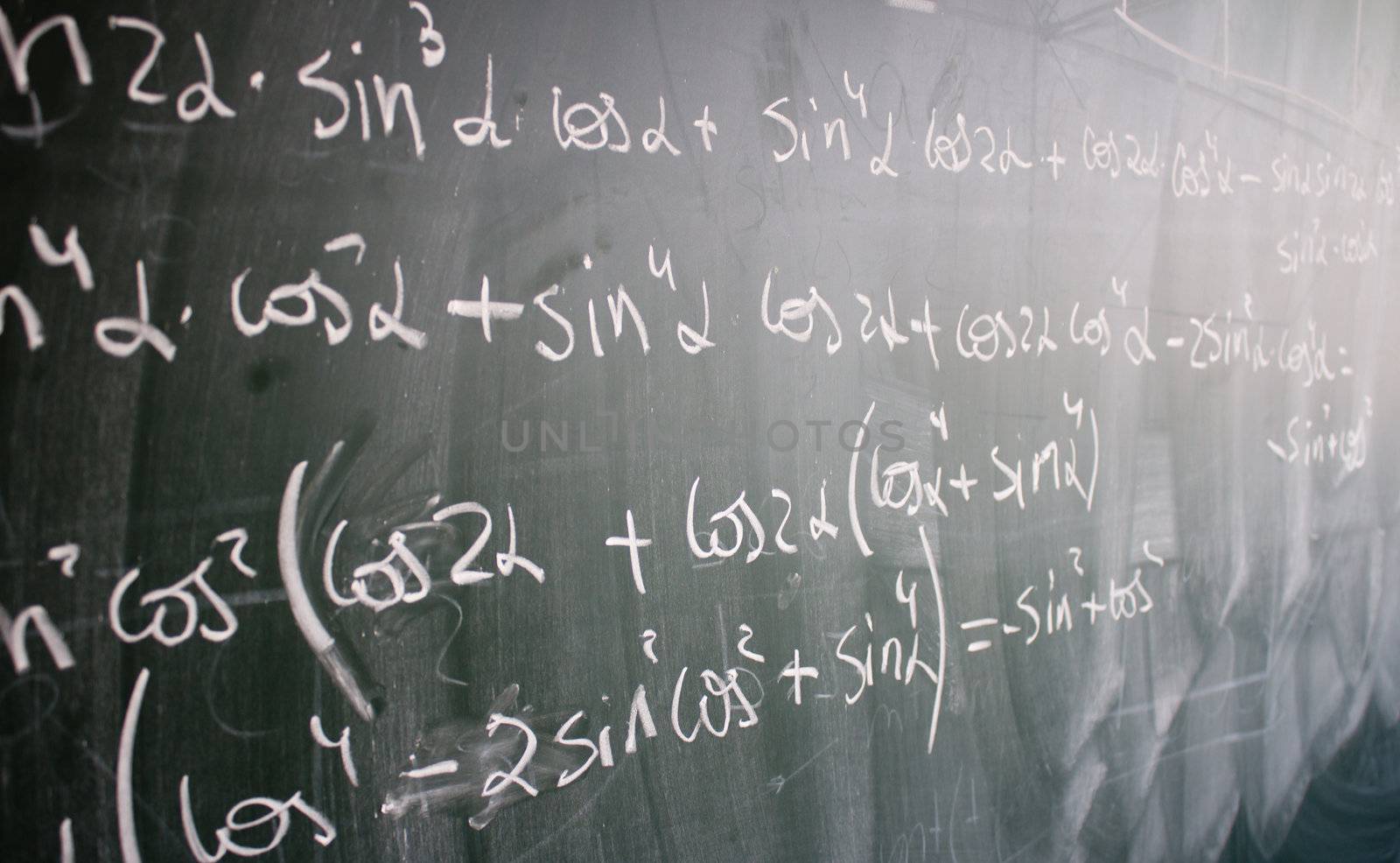 Blackboard with trigonometric formulas and numbers written on it