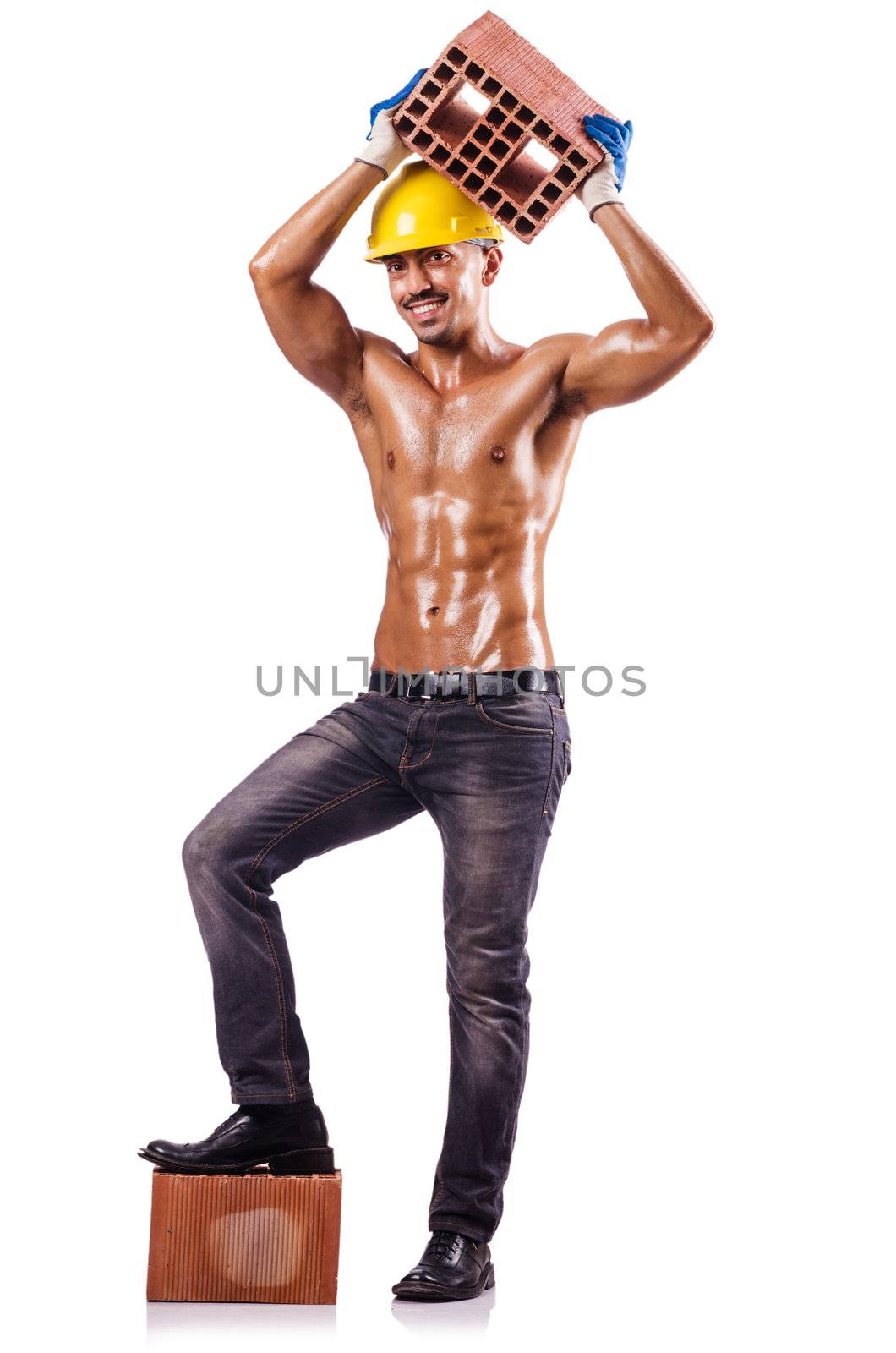Muscular builder with bricks on white