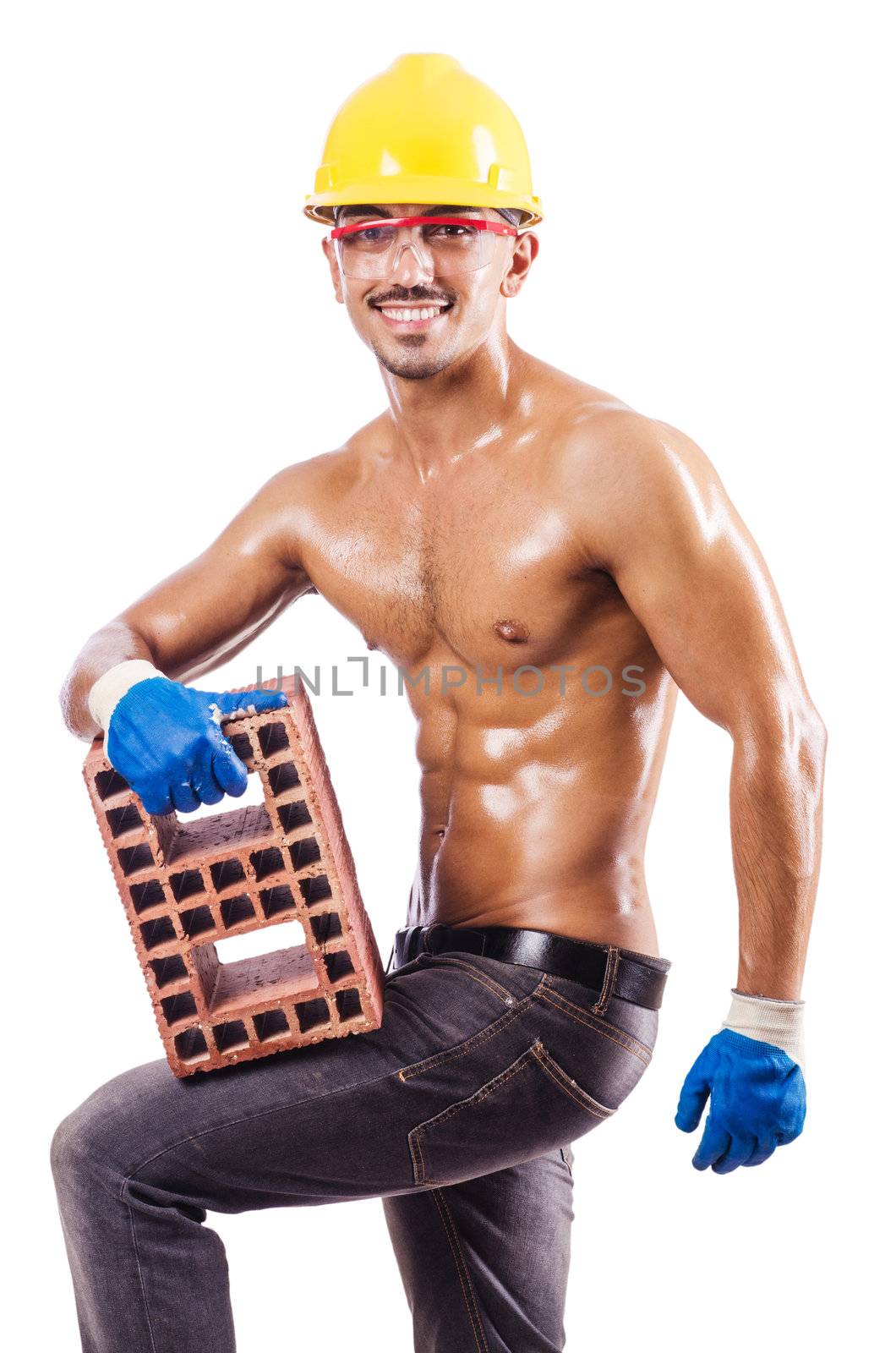 Muscular builder with bricks on white