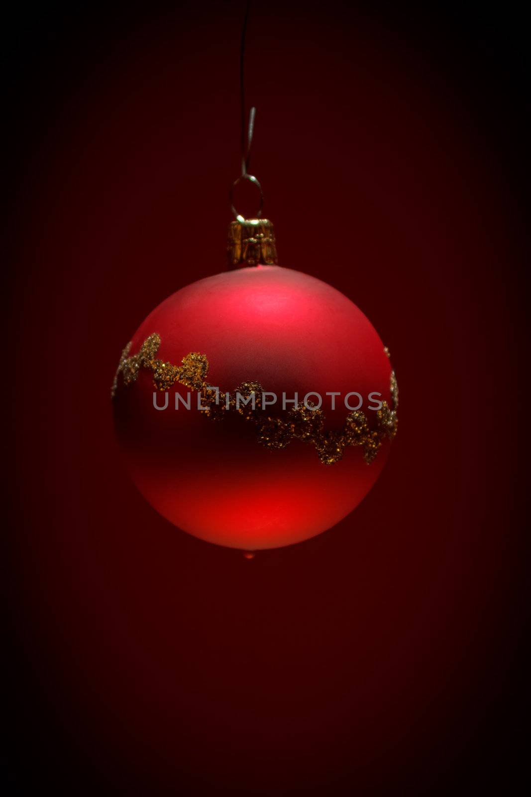 red christmas ball on dark red background