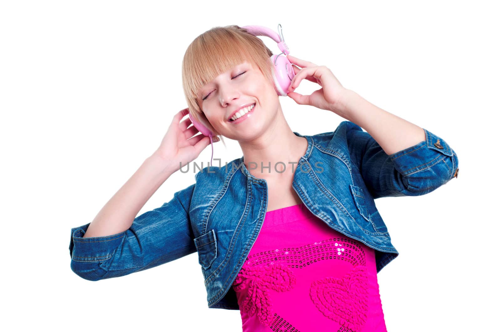 Young attractive woman listing to music with headphones against white background