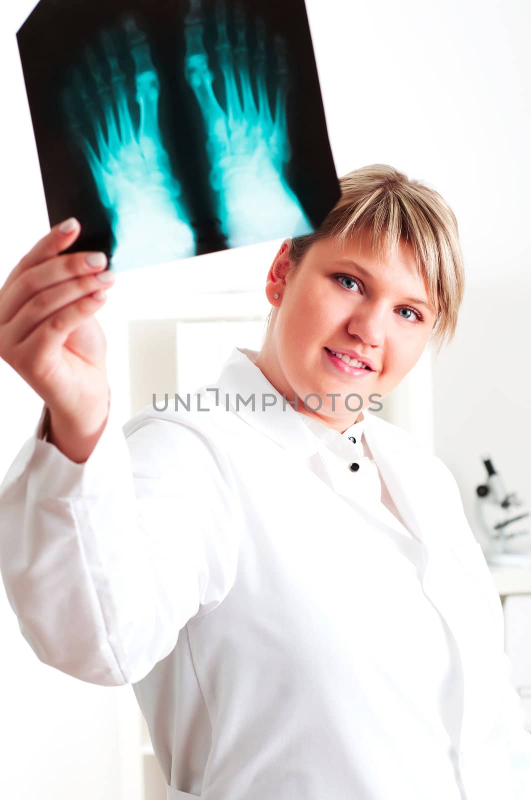 woman doctor looks at x-ray film, smile