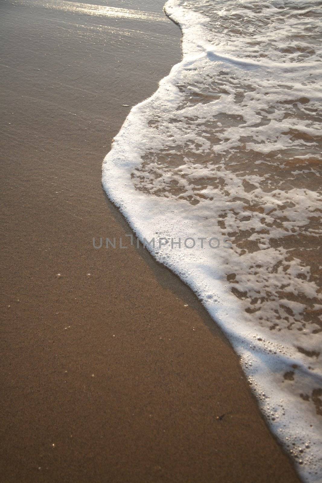 water over seashore at a beach in Asturias Spain