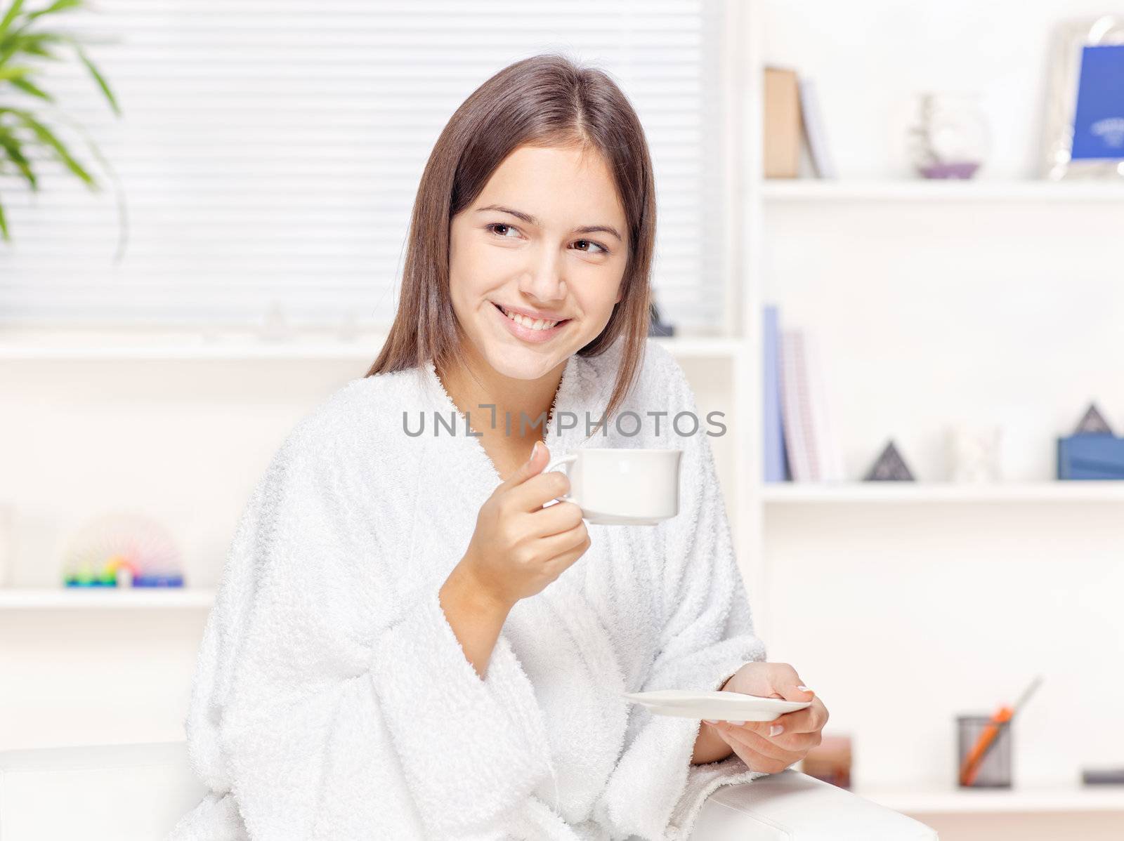 Woman in bathrobe relaxing at home by imarin