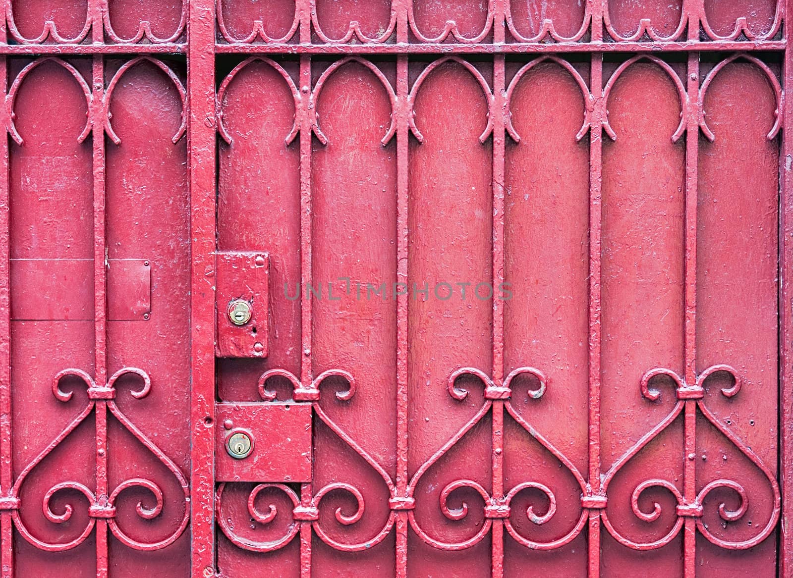 A red gate with a key lock. The gate is closed.