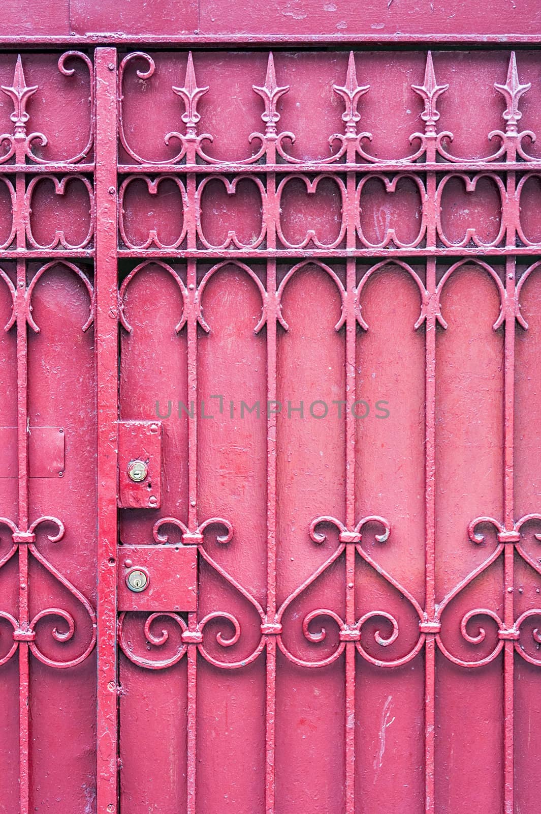 A red gate with a key lock. The gate is closed.