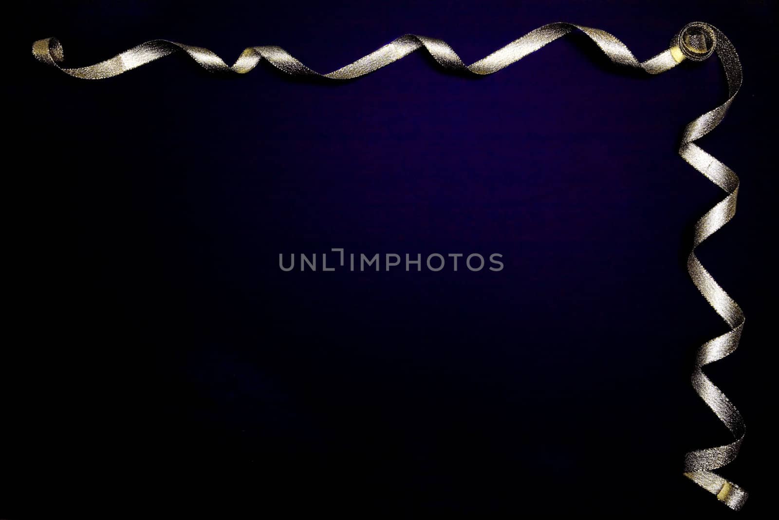 Gold ribbon on dark grunge background by jarenwicklund
