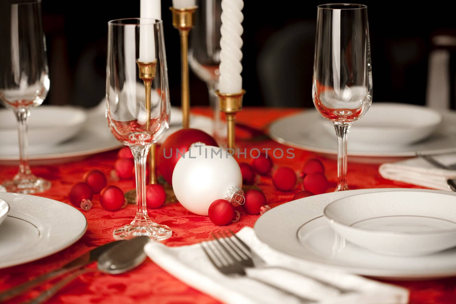 Red and white Christmas table setting, shallow depth of field, focus on ornament