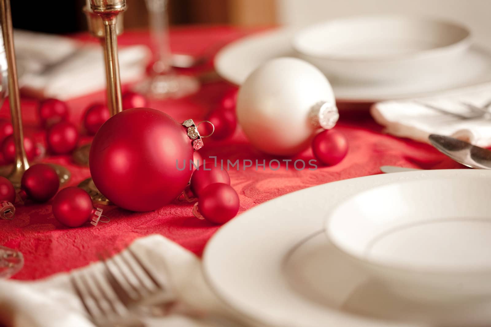 Red and white Christmas table setting, shallow depth of field, focus on ornament