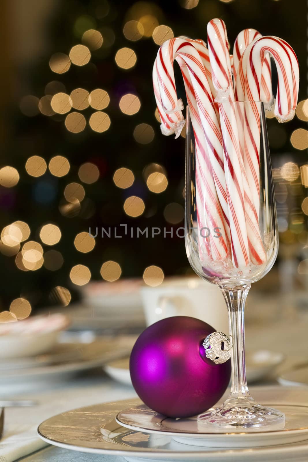 Candy canes and ornaments on Christmas dining table by jarenwicklund
