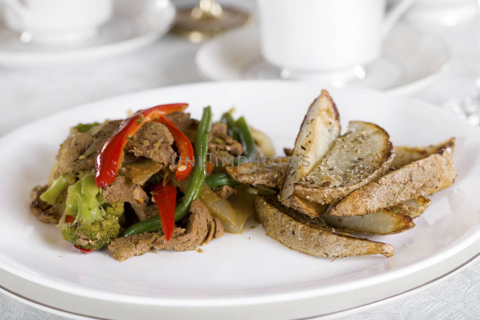 Beef and broccoli stirfry on table by jarenwicklund