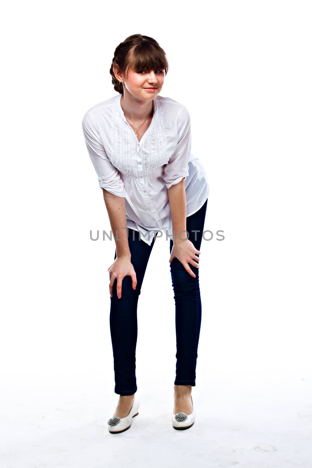 Young and funny girl in a white shirt and dark blue jeans