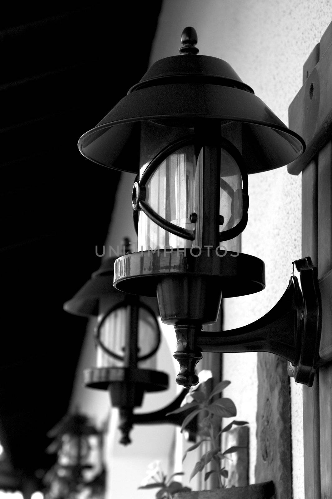 Wrought Iron Street Lamps Old-Fashioned on Building Wall outdoors