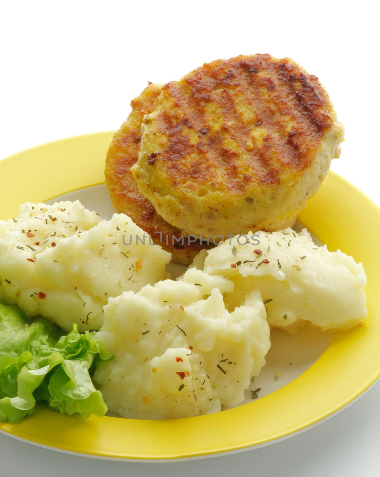 Mashed Potato and Meat Cutlets with Lettuce on Yellow Plate closeup