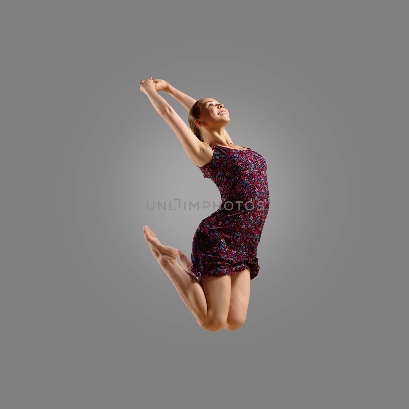 dancer jumping on a gray background, having a fun