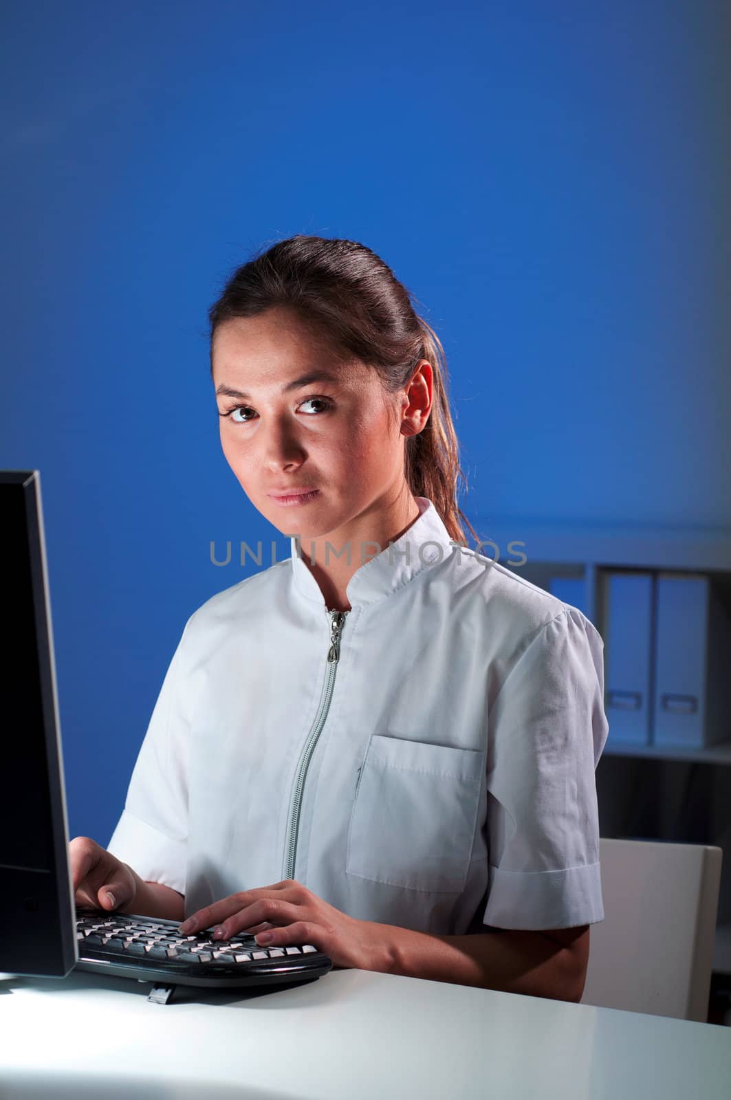 beautiful young woman doctor working at night in the office