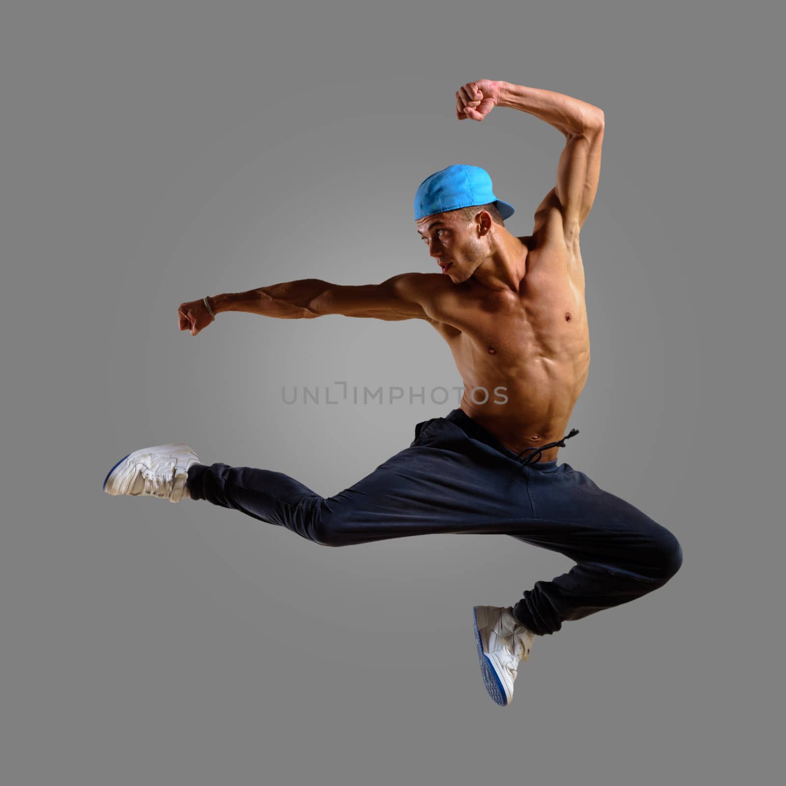 dancer jumping on a gray background, having a fun