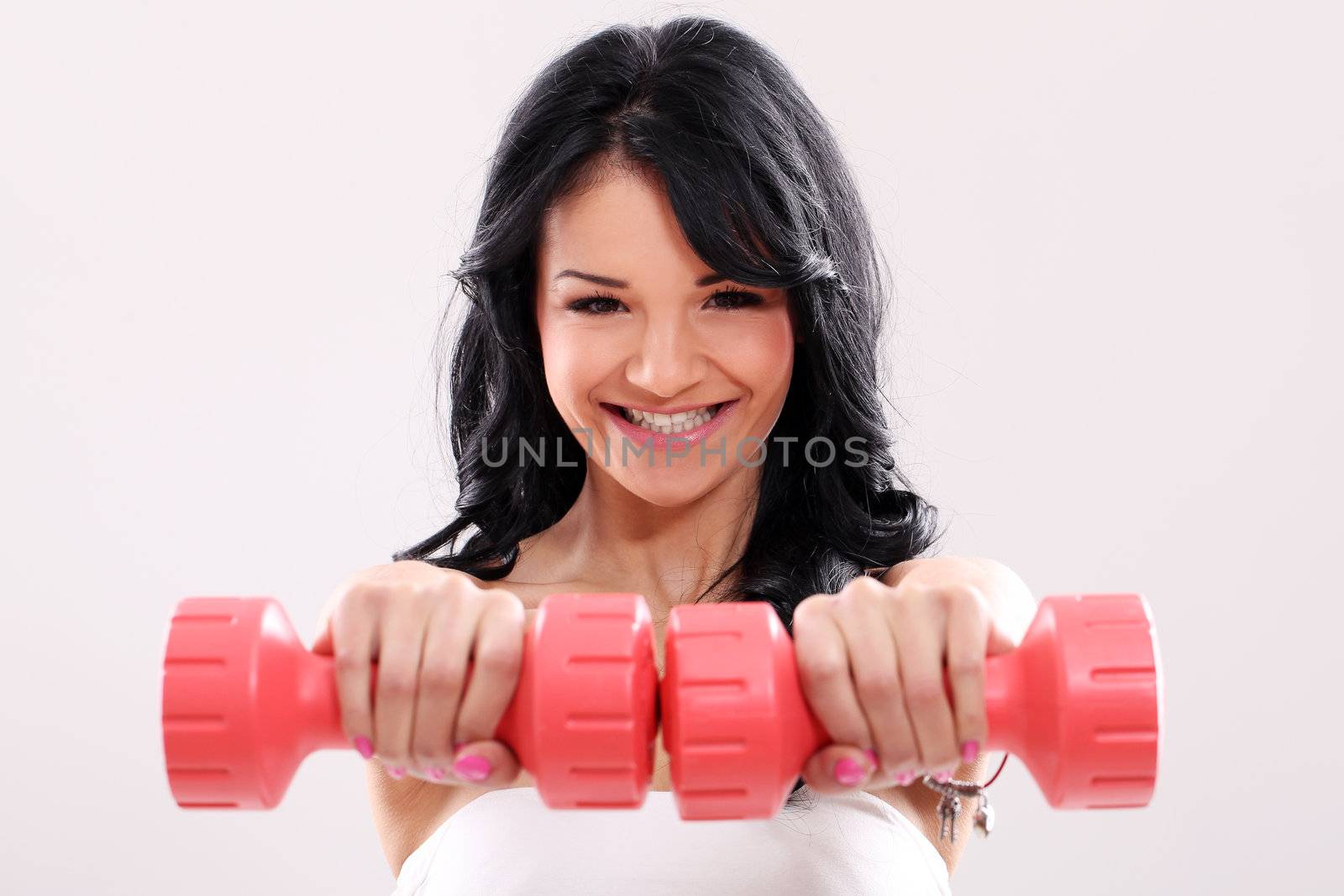 Portrait of Smiling fitness girl with red dumbbells