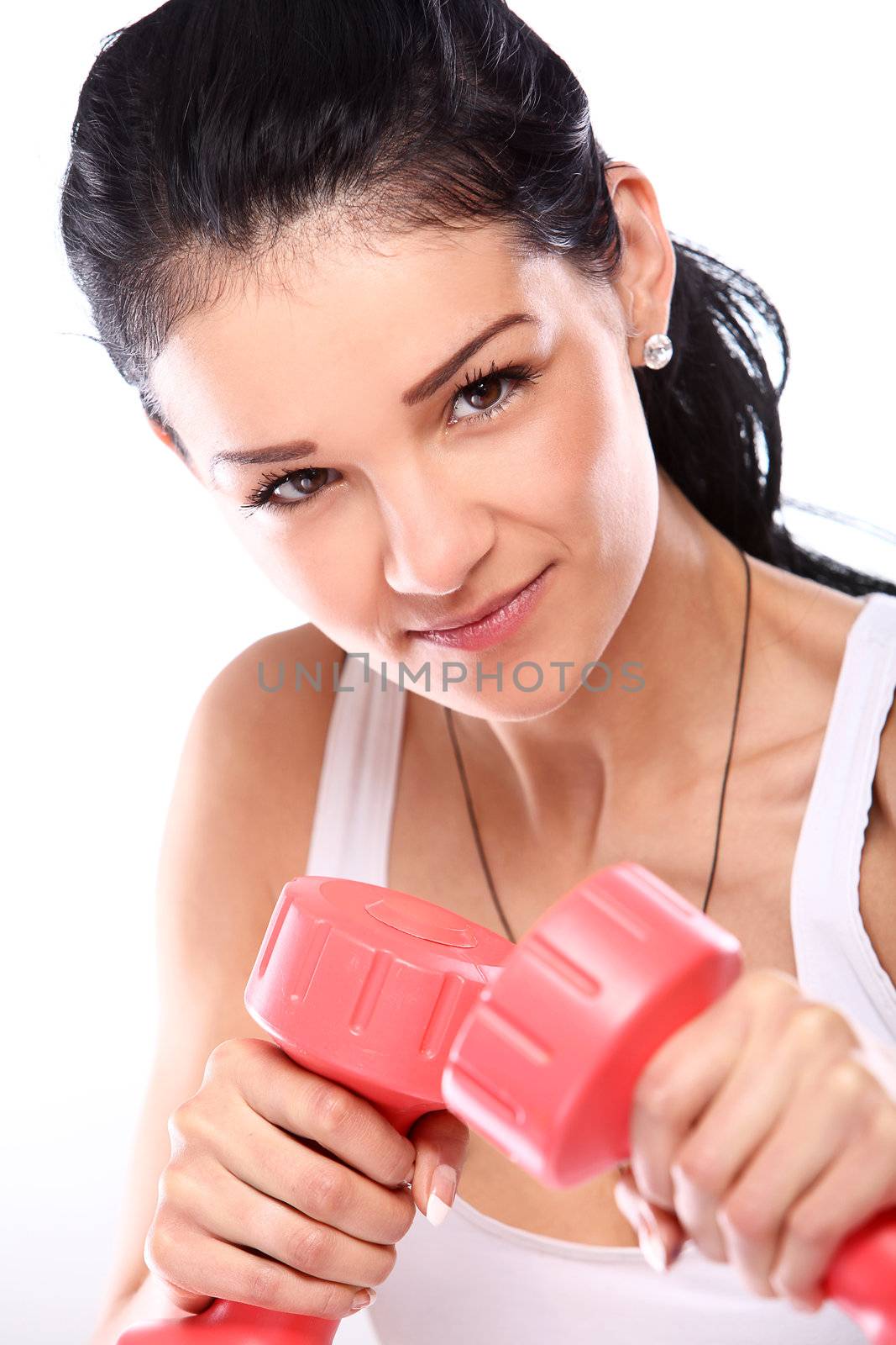 Cute and young girl do exercises with red dumbbells