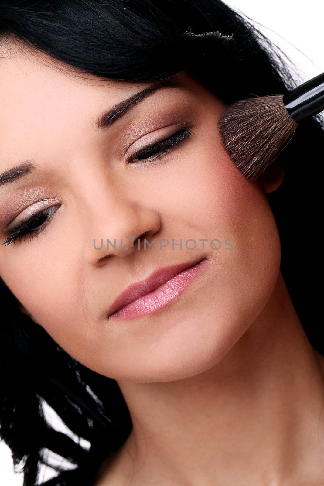 Portrait of young and beautifull girl with brush on her face