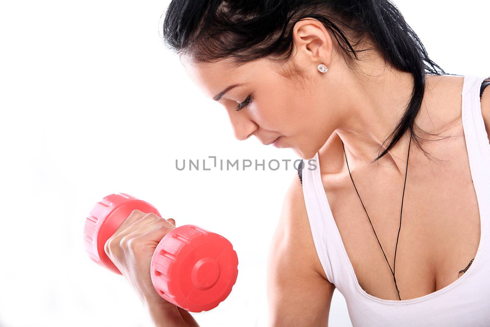 Cute and young girl do exercises with red dumbbells