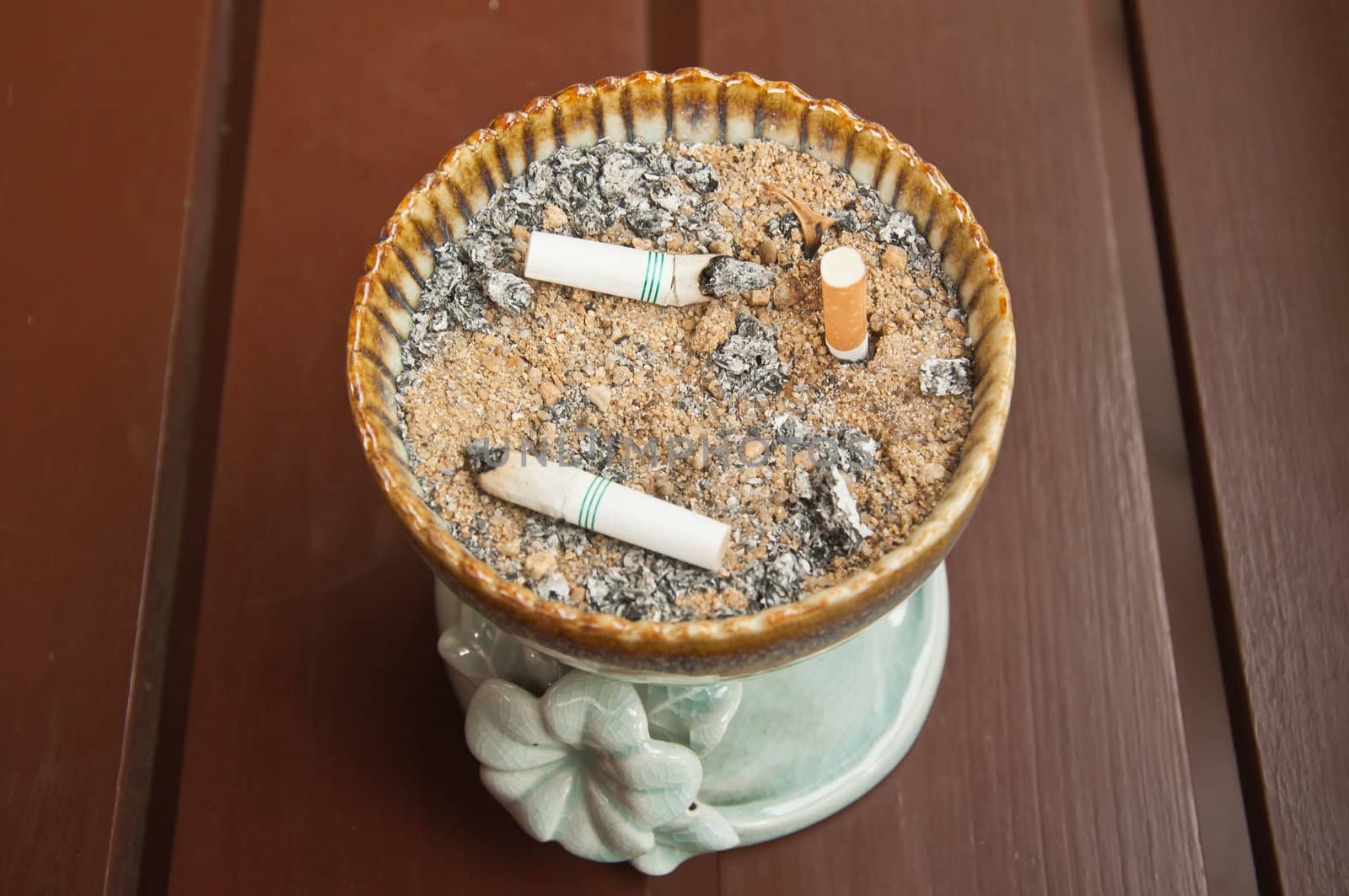 ashtray with cigarettes and sand