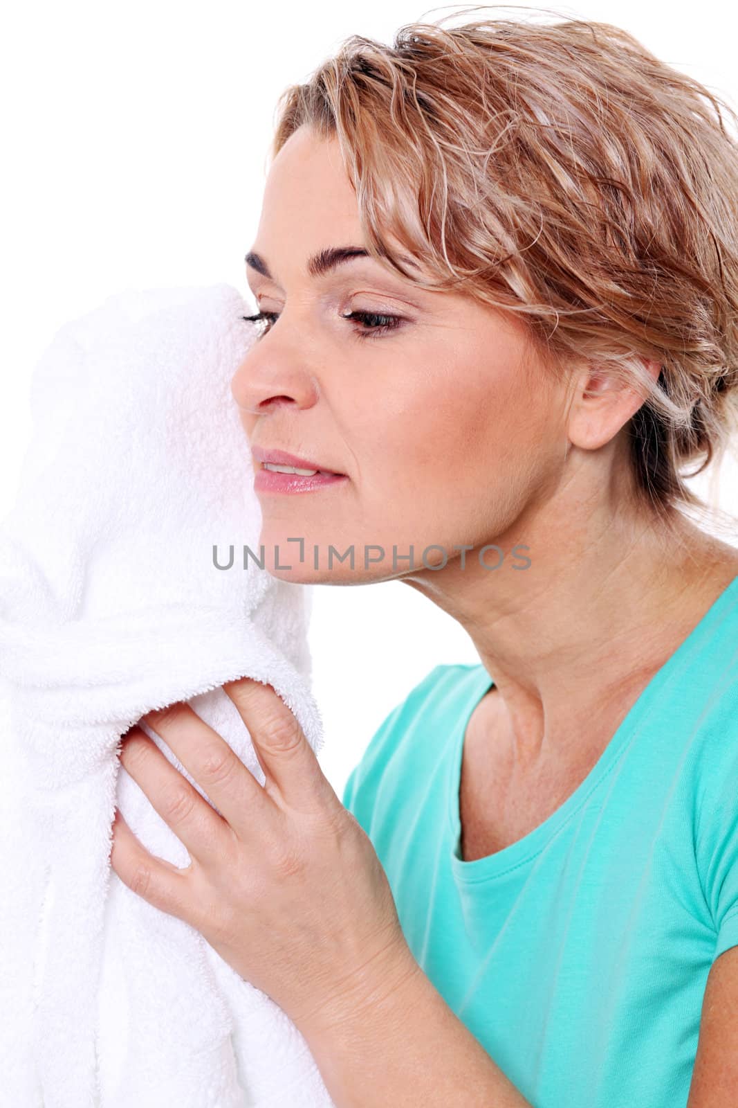 Beautiful mid aged woman with towel isolated on a white