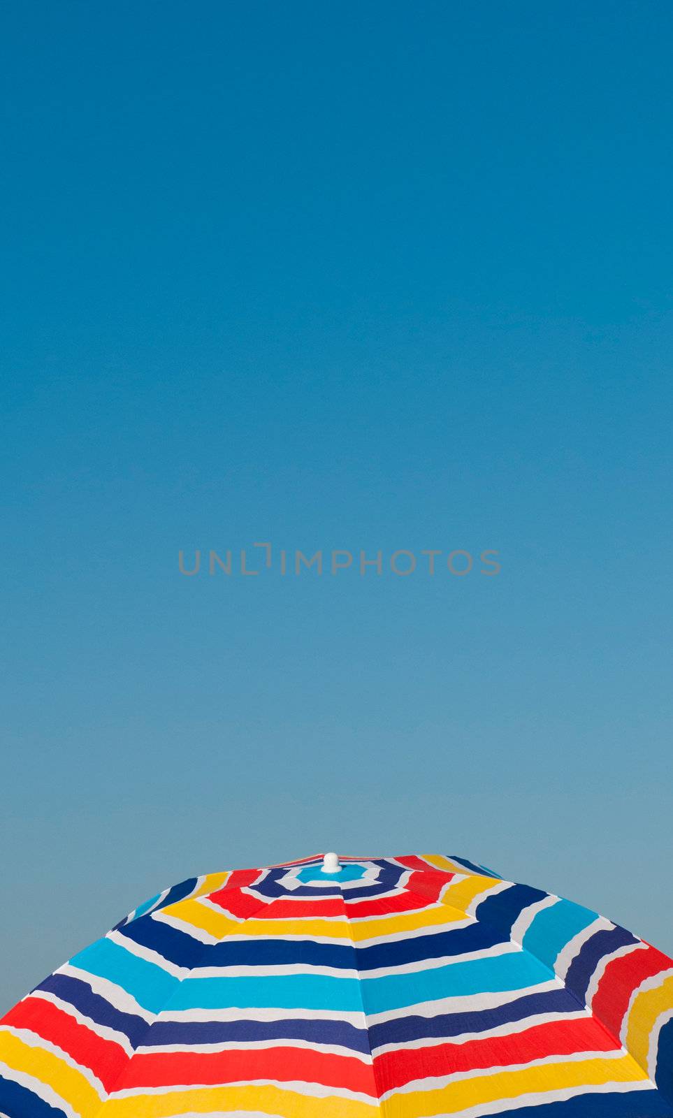 colorful beach umbrella against a blue sky background