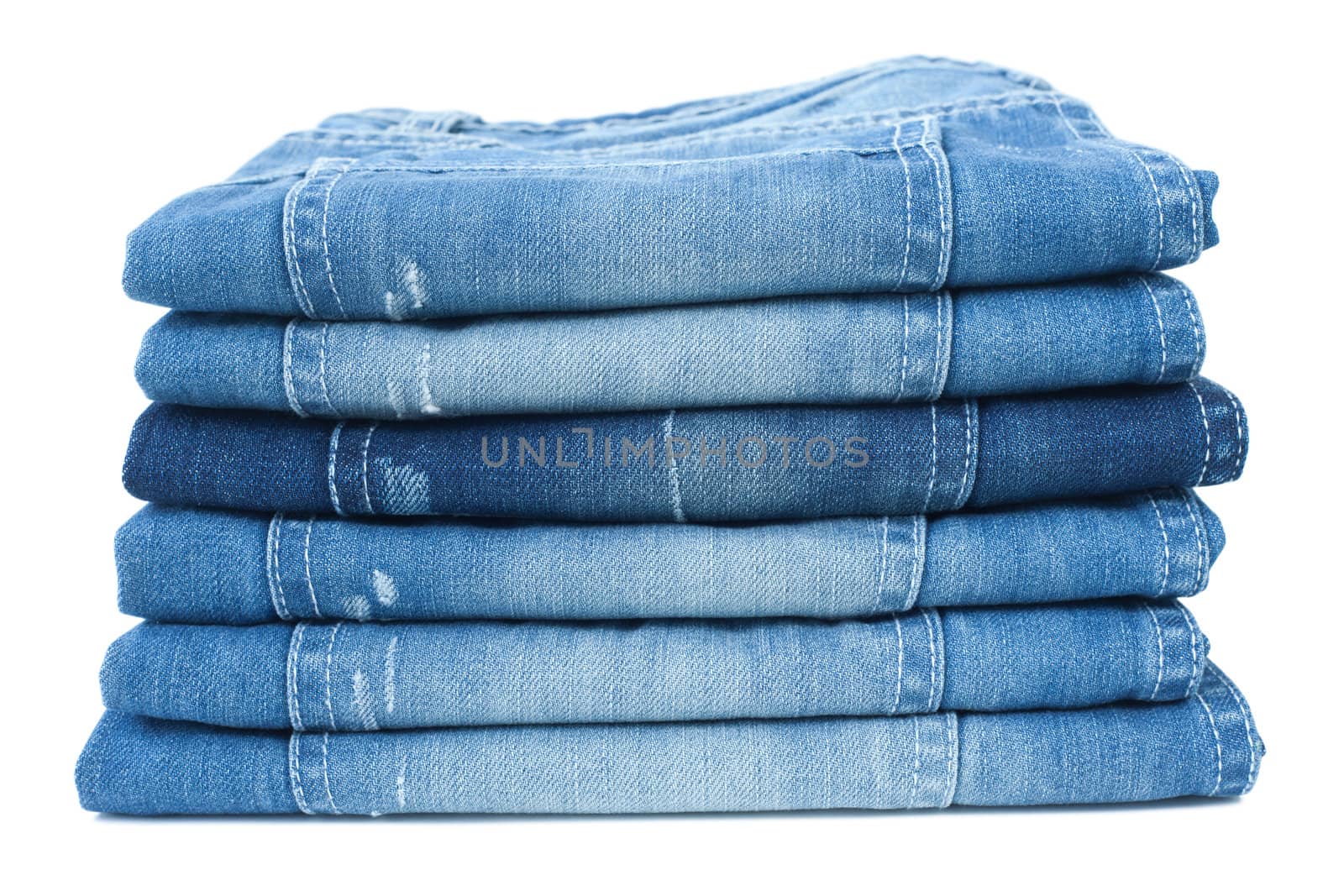 Stack of blue jeans isolated on white background