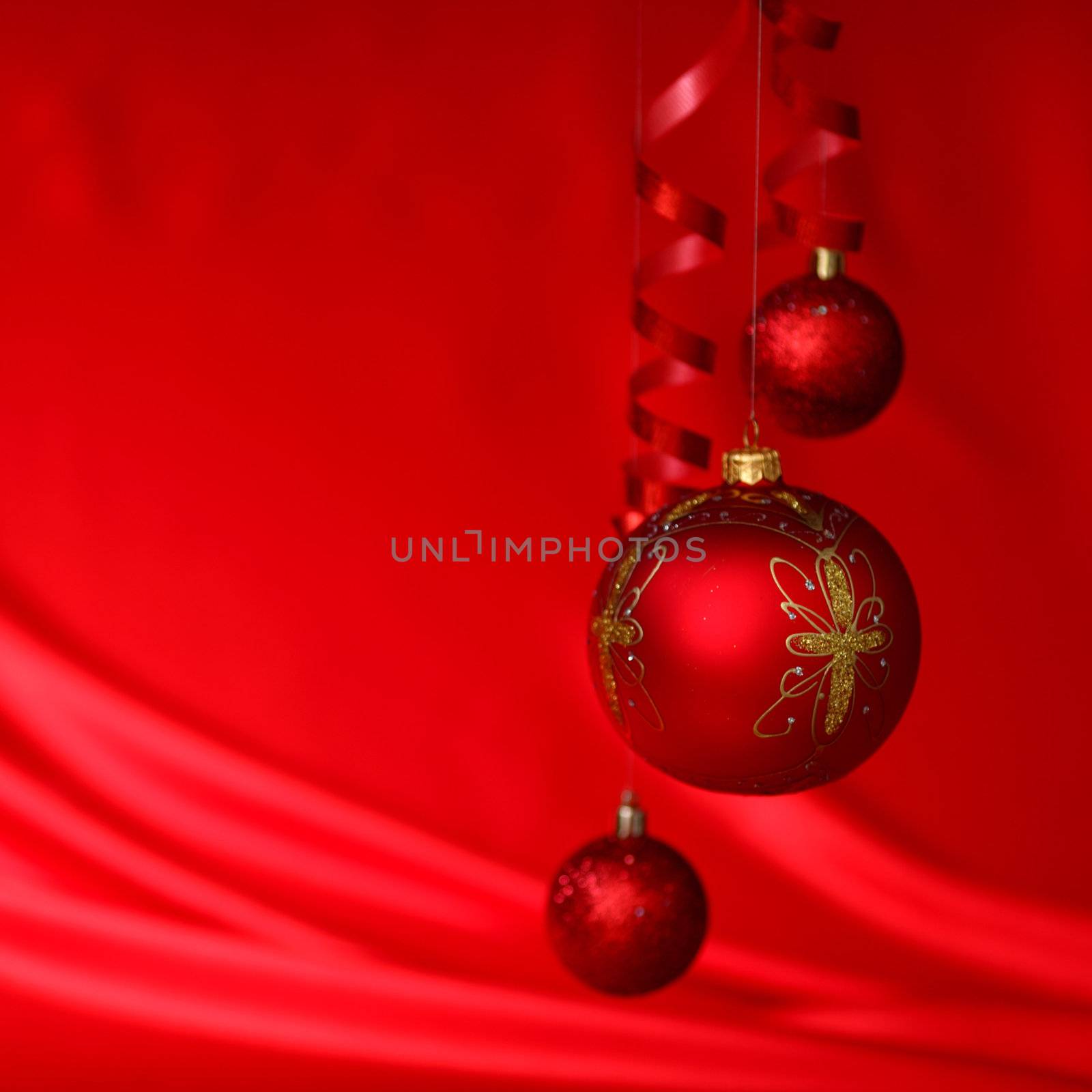  christmas balls on red satin background