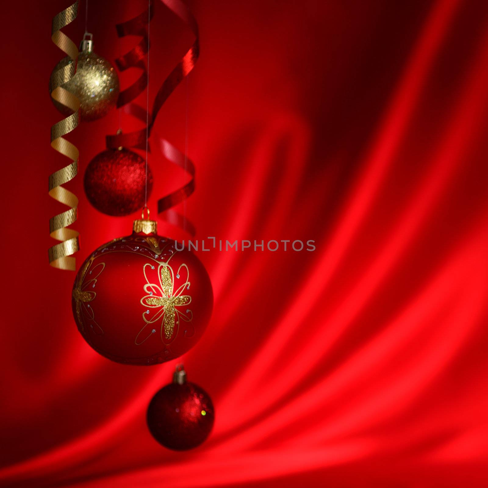  christmas balls on red satin background