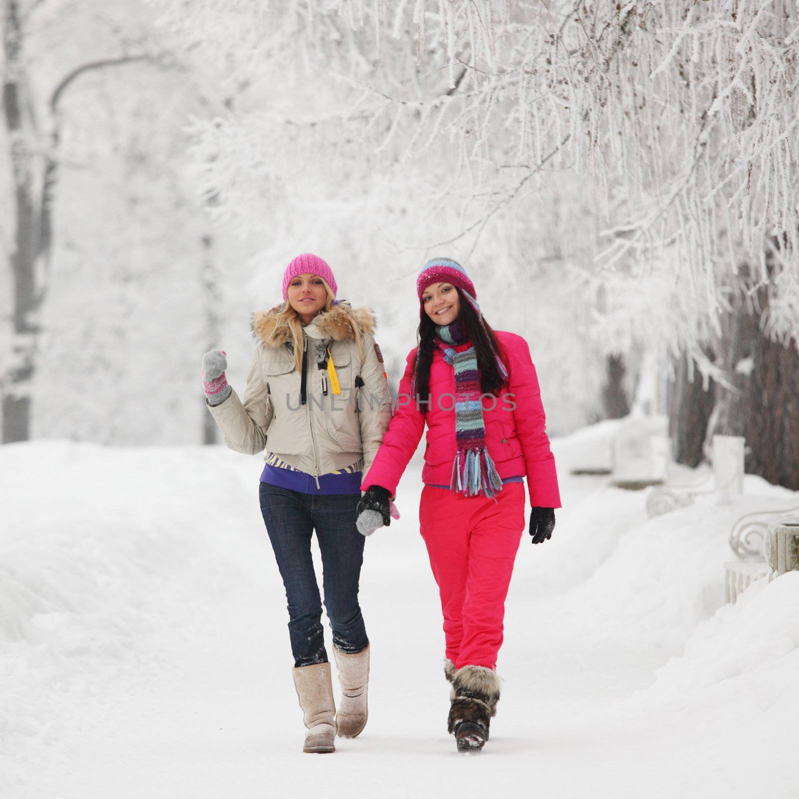 two winter women run by snow frosted alley