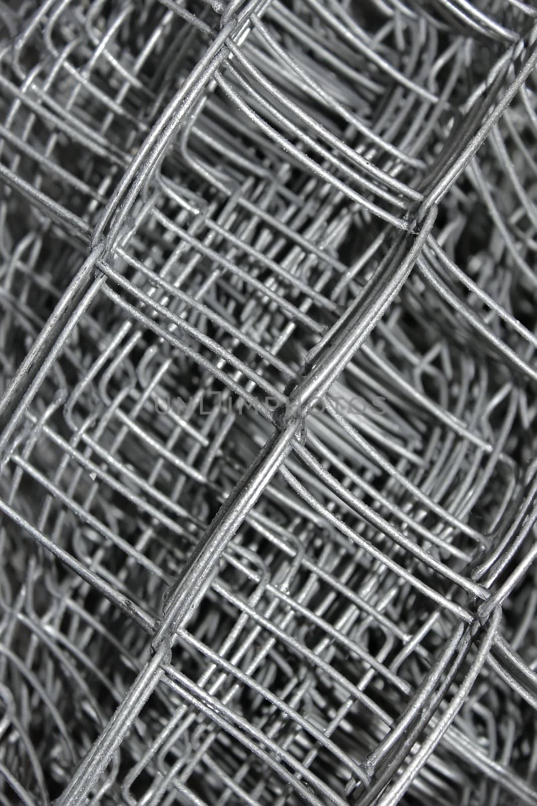 Steel mesh with water drops composed in multiple layers close-up