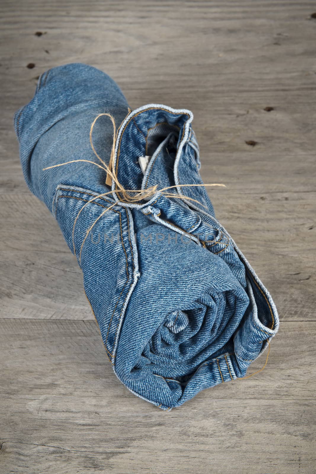 Rolled jeans arranged in a pyramid  by angelsimon