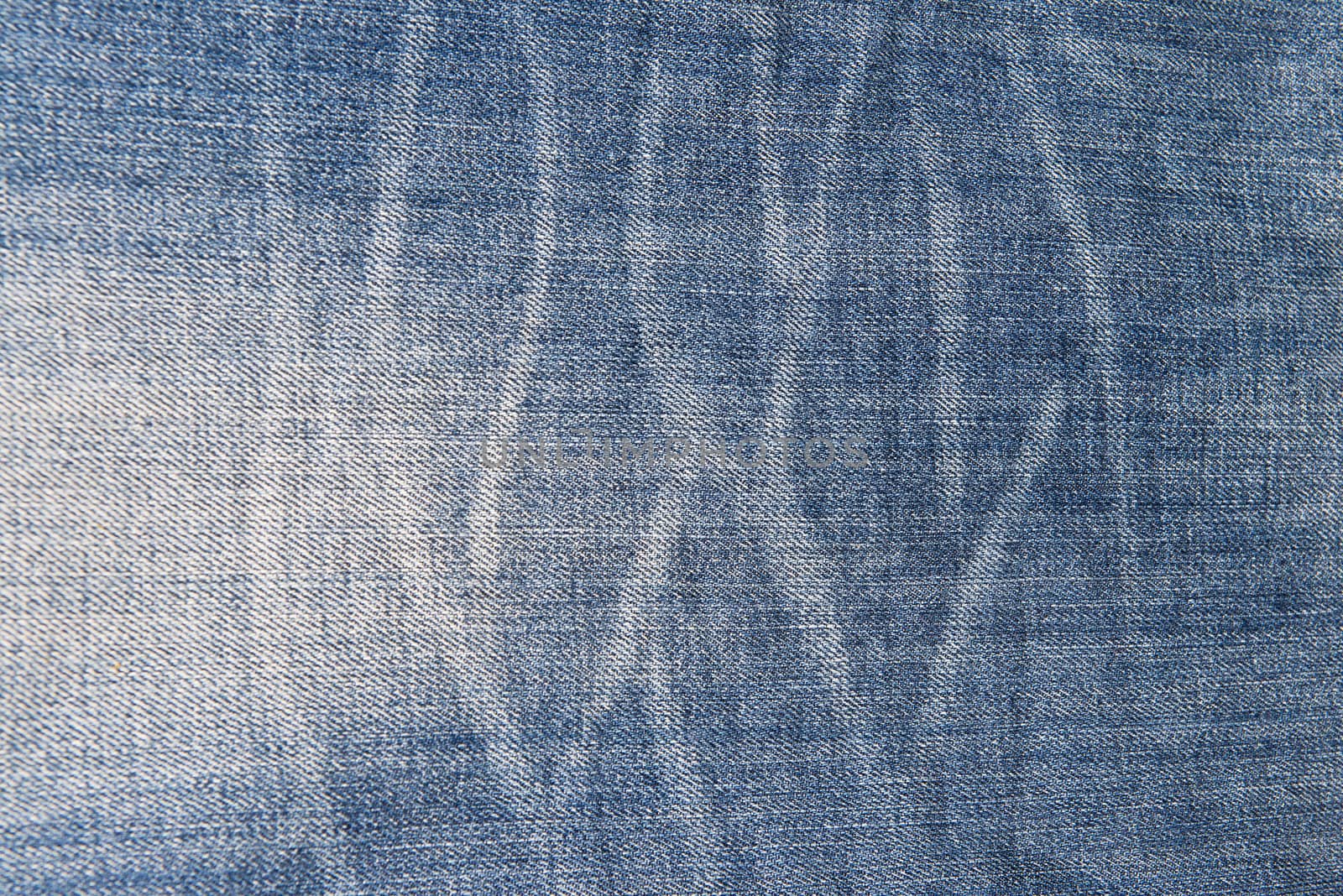 Old and worn blue jeans pattern background in a king size
