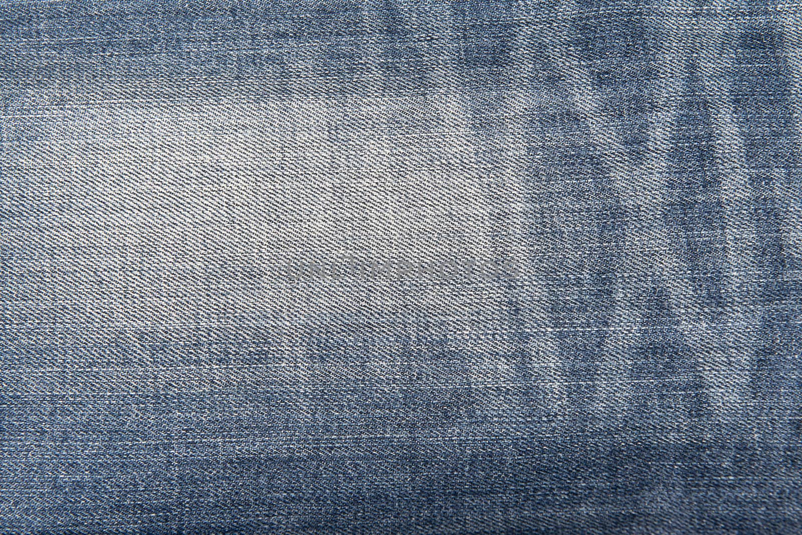 Old and worn blue jeans pattern background in a king size
