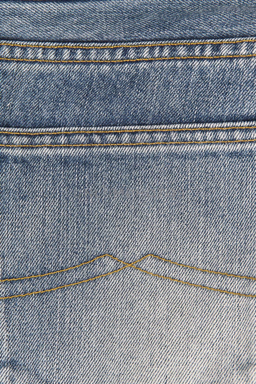 Detail of the classic seams in old blue jeans