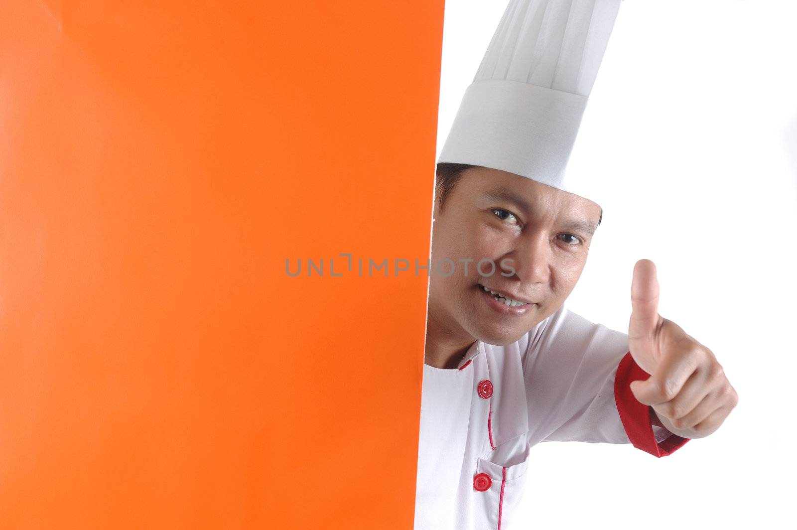 chef gives thumbs up sign with orange blank space  by antonihalim