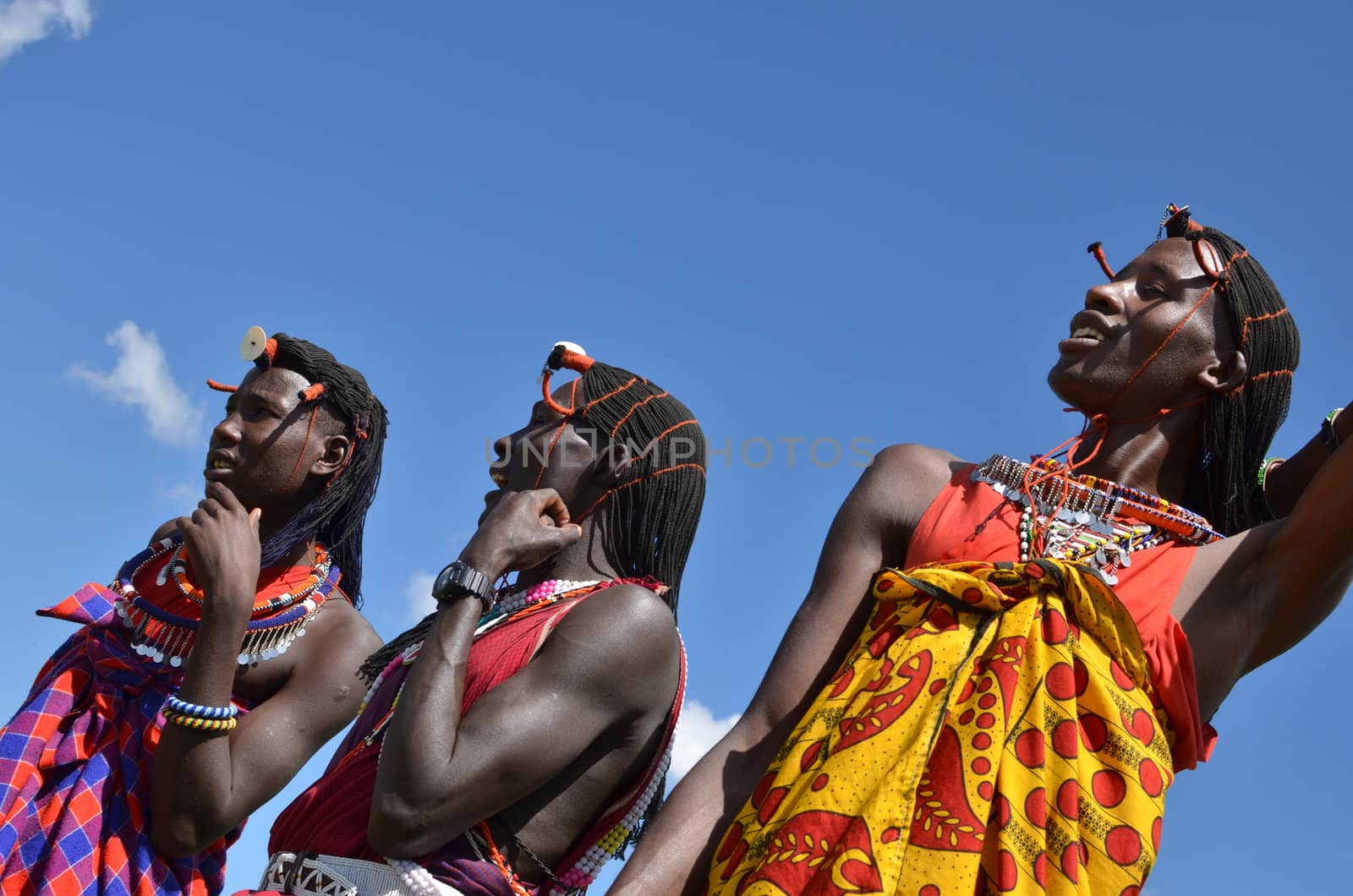 Village Masai Mara, Kenya - October 17, 2011: A yuong Masai welcomes tourists with the traditional jumping ceremony .