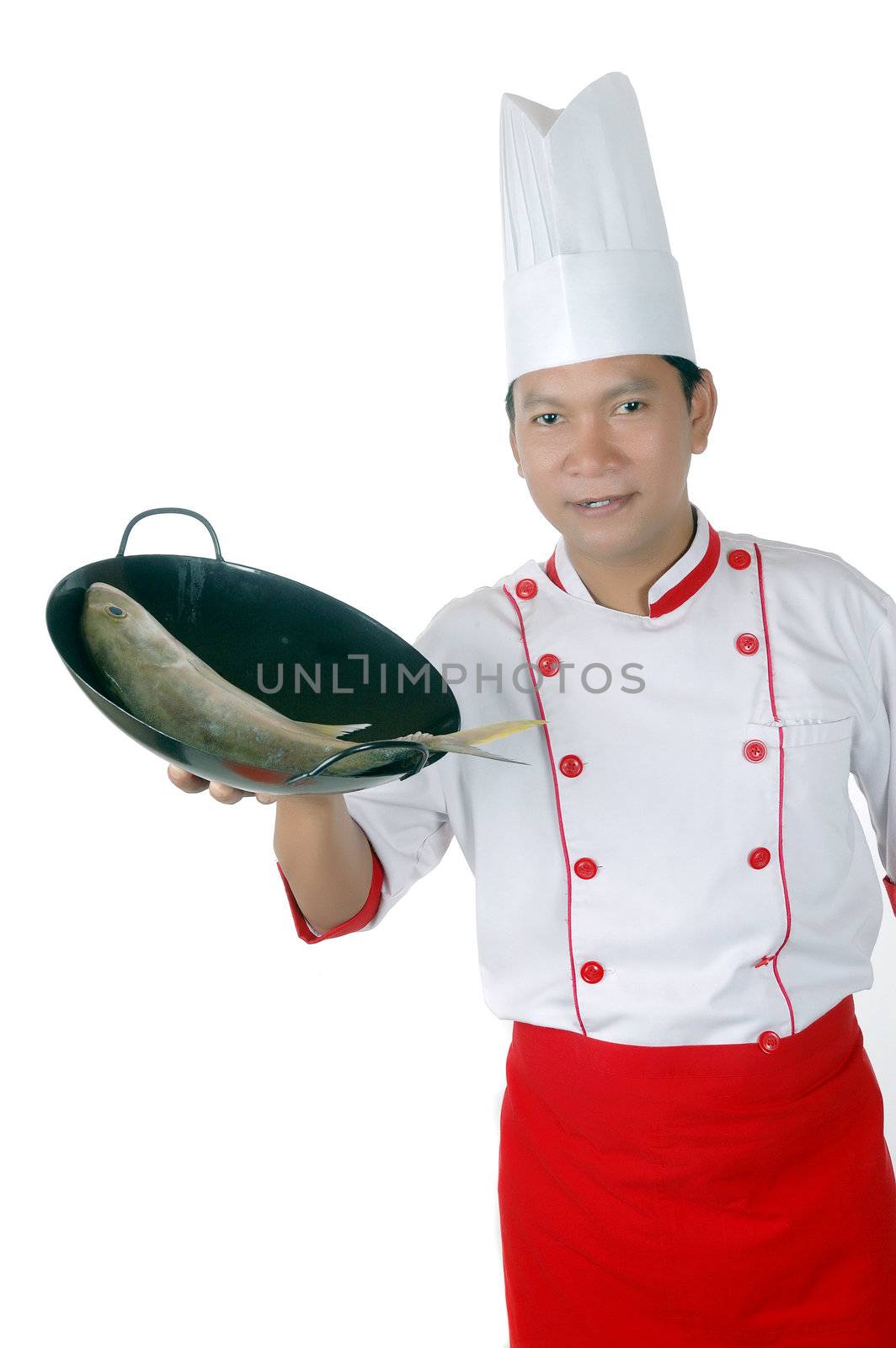 chef holding raw fish on a black frying pan by antonihalim
