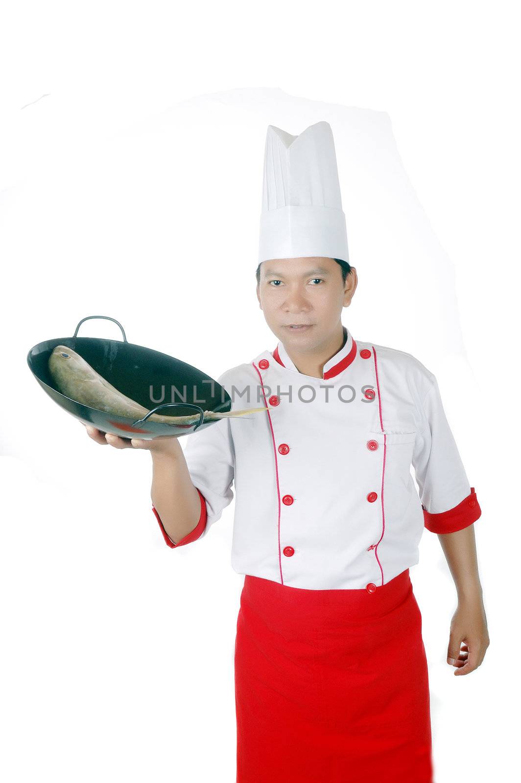 chef holding raw fish on a black frying pan  by antonihalim