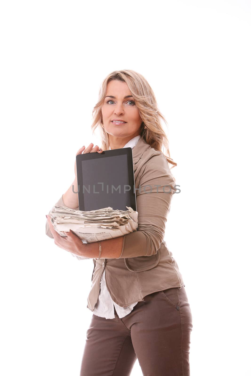 Mid aged woman in office suit with tablet pc and newspapers