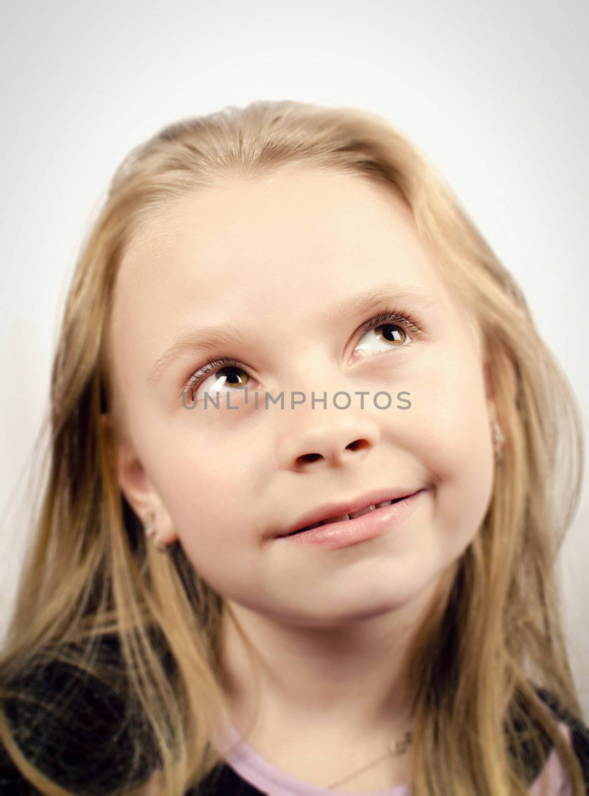 Little girl looking up and smilling