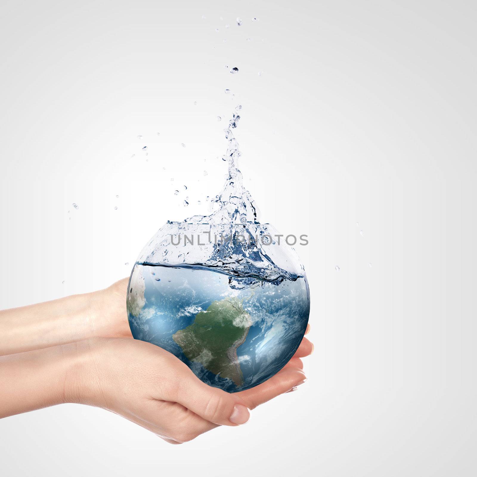 Globe in human hand against blue sky. Environmental protection concept. Elements of this image furnished by NASA