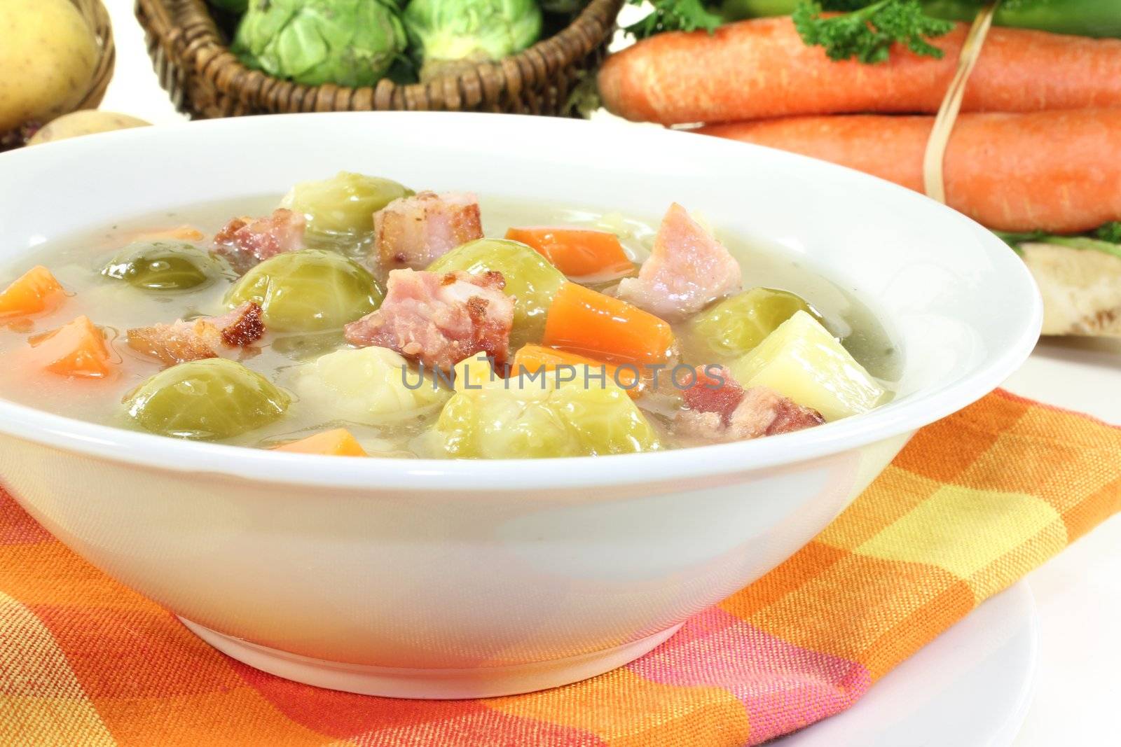 fresh Brussels sprouts soup with potatoes, leeks, carrots, celery and bacon