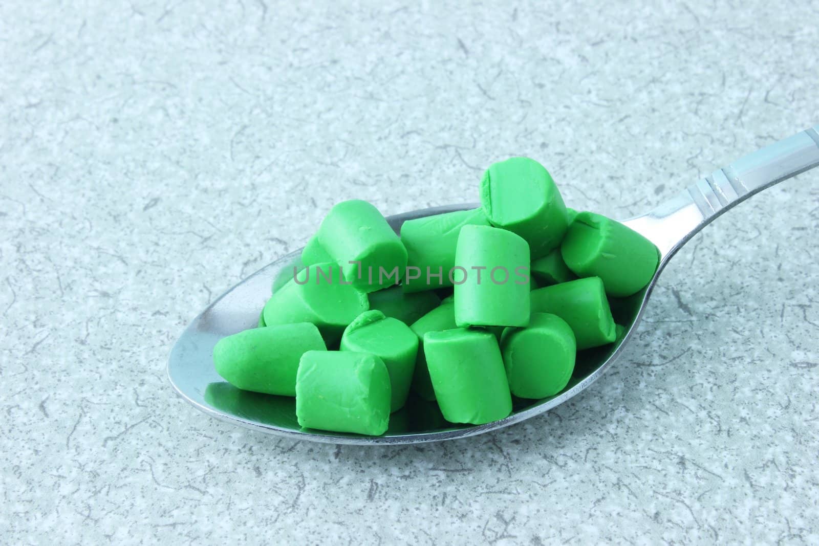 A Spoonful of green plasticine pieces