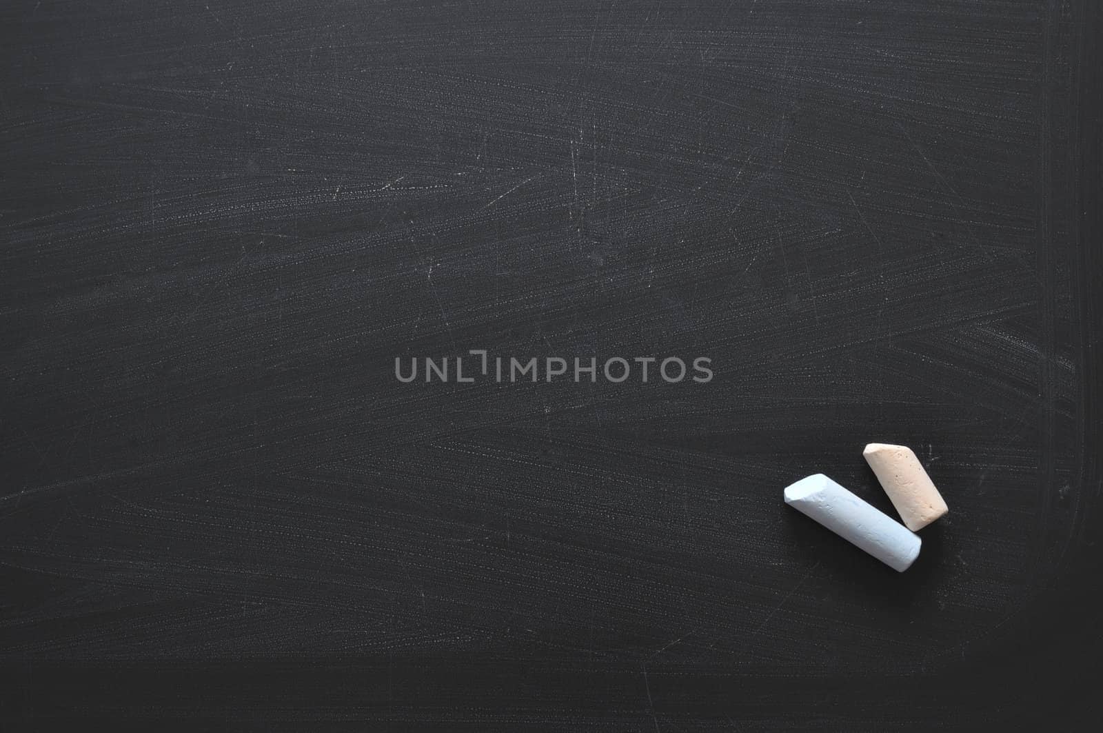 hi-res black chalkboard background with two color chalk pieces 