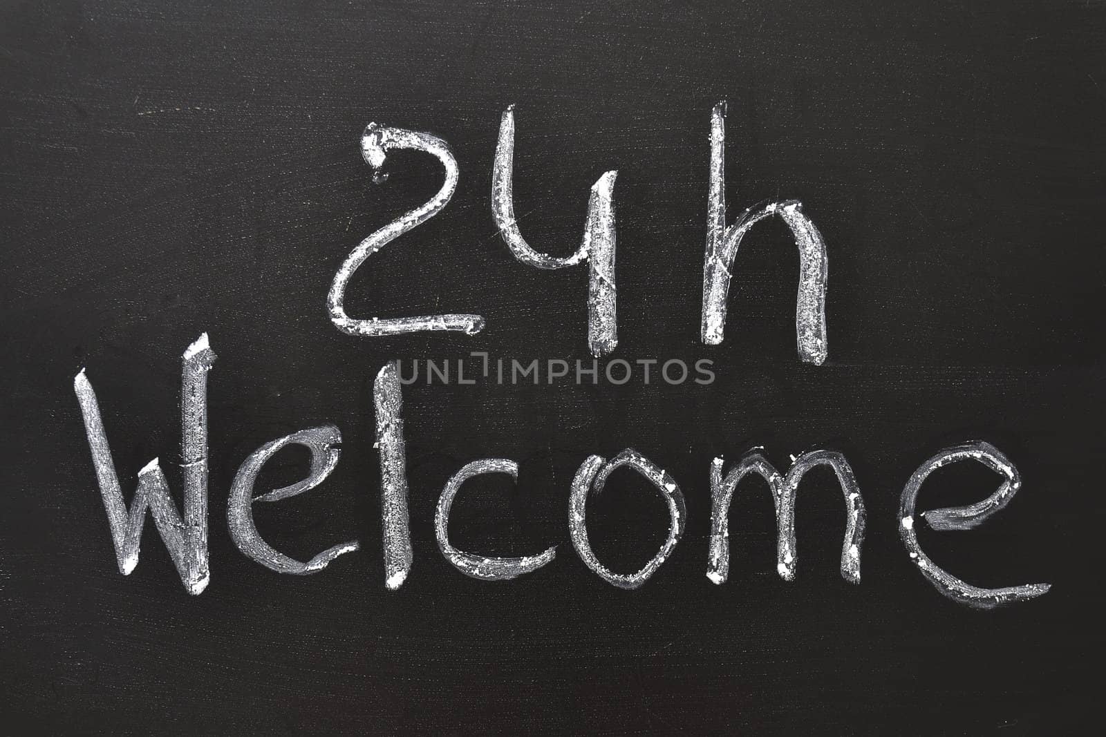 Handwritten 24 h Welcome sign on the blackboard