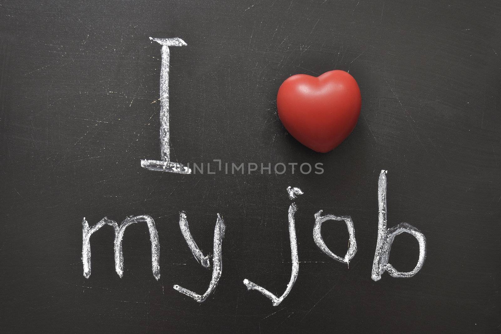 I love my job -  positive concept handwritten on black chalkboard with volume red heart symbol