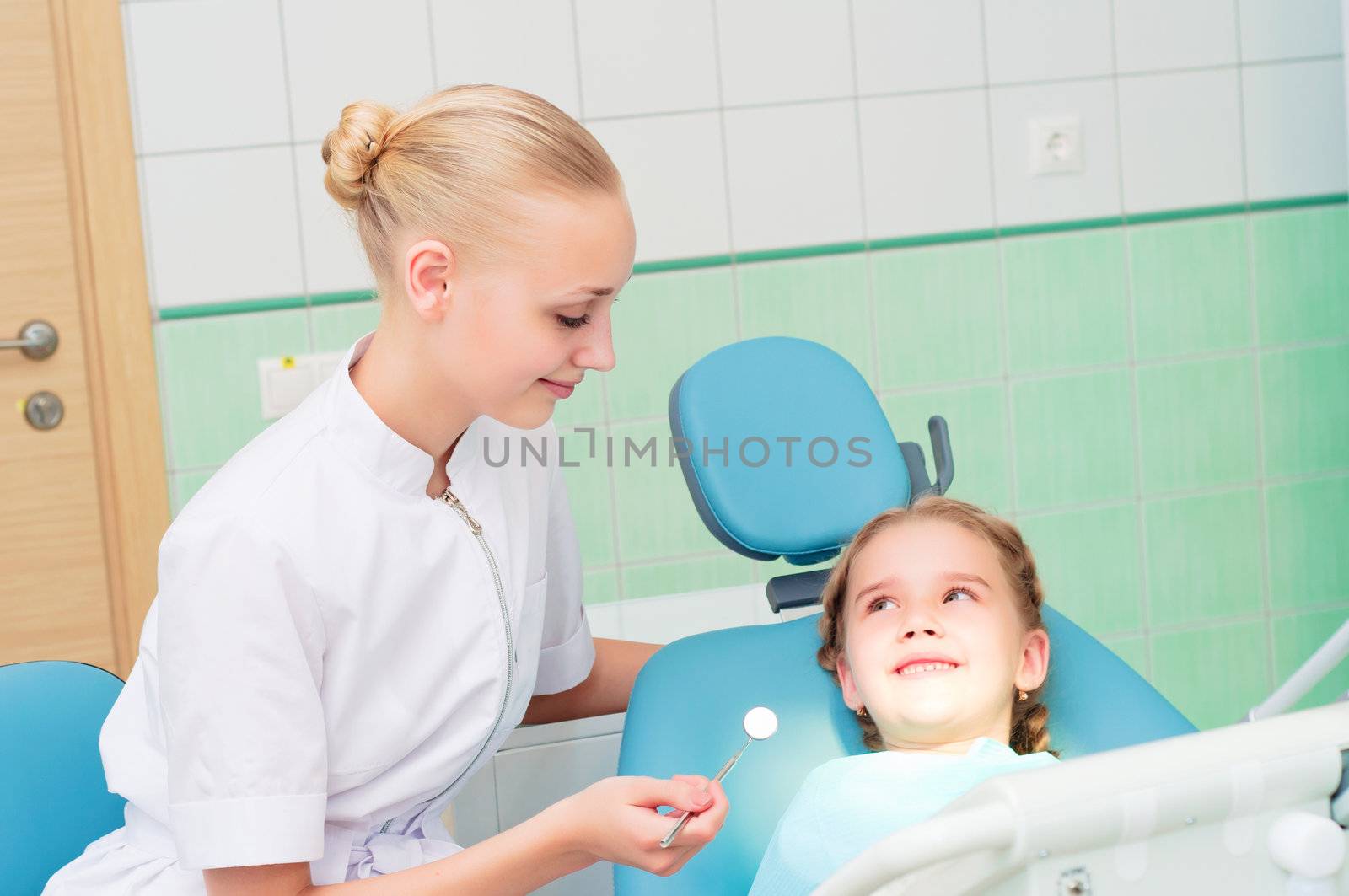 young doctor woman and girl in dentist office by adam121